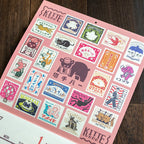 Close view of a stamp-themed artwork in the ob1toy LP Wall Calendar 2027