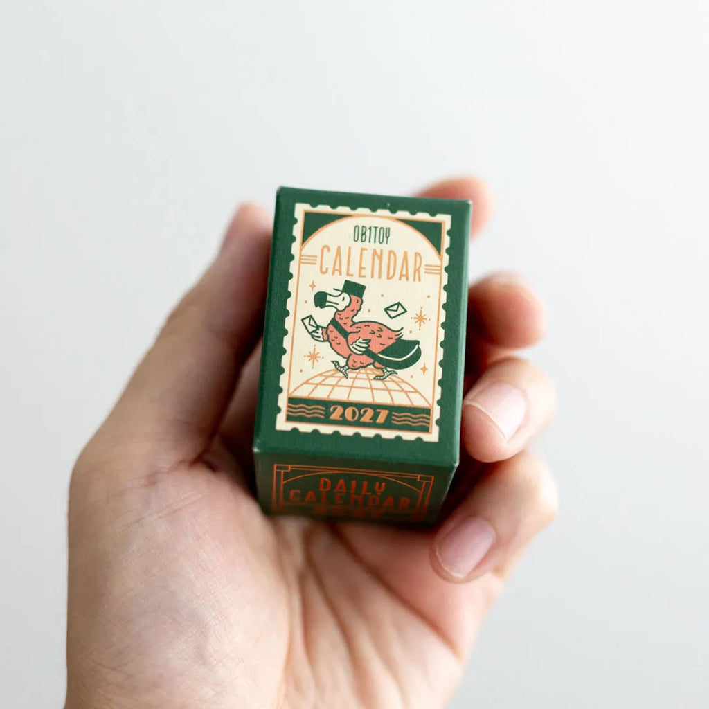 ob1toy Mini Daily Calendar 2027 box held in one hand for scale