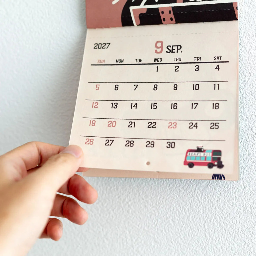 Hand holding the perforated calendar section of the ob1toy Mini Wall Calendar 2027
