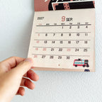 Hand holding the perforated calendar section of the ob1toy Mini Wall Calendar 2027