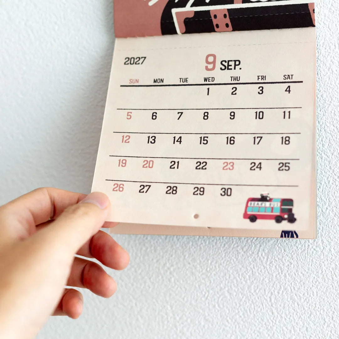 Hand holding the perforated calendar section of the ob1toy Mini Wall Calendar 2027