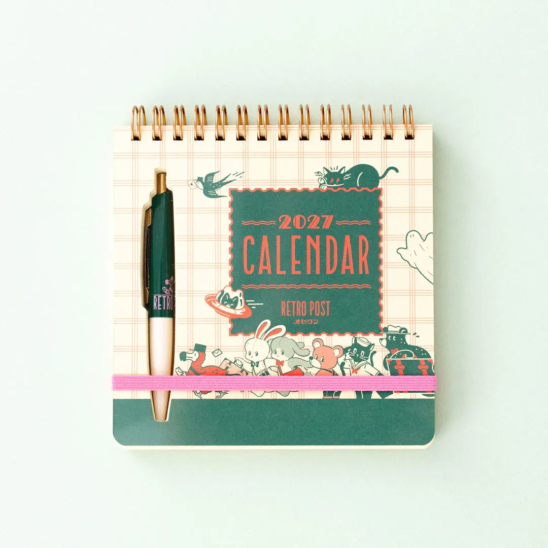 ob1toy Weekly Calendar 2027 closed, with its ballpoint pen held by the elastic band