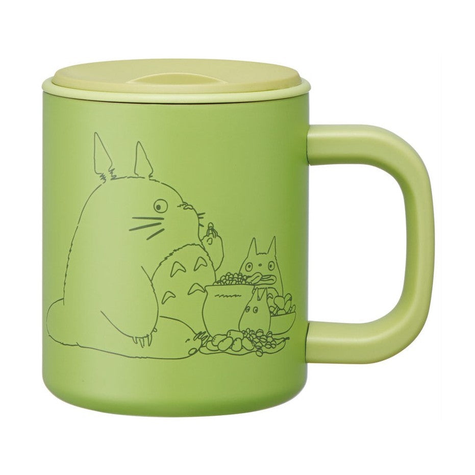 Front view of light green My Neighbor Totoro vacuum insulated mug with black line art design