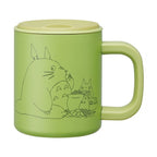 Front view of light green My Neighbor Totoro vacuum insulated mug with black line art design