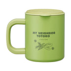 Side view of light green Totoro travel mug featuring Studio Ghibli copyright text and leaf motif