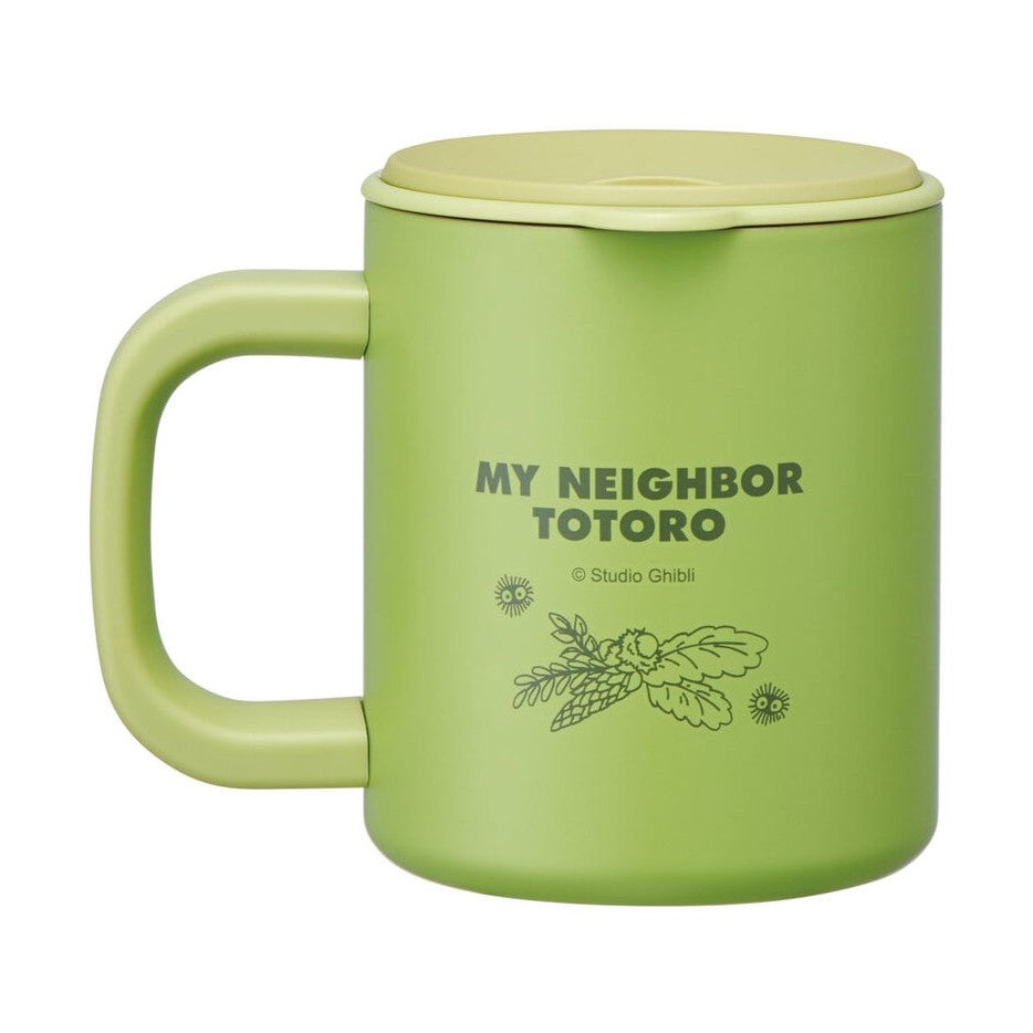 Side view of light green Totoro travel mug featuring Studio Ghibli copyright text and leaf motif