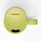 Close-up of light green Totoro mug lid showing OPEN CLOSE embossed text and drinking slot