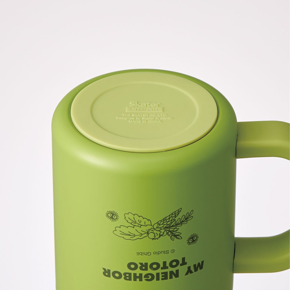 Light green Totoro mug close-up displaying Skater branding and Studio Ghibli licensed artwork