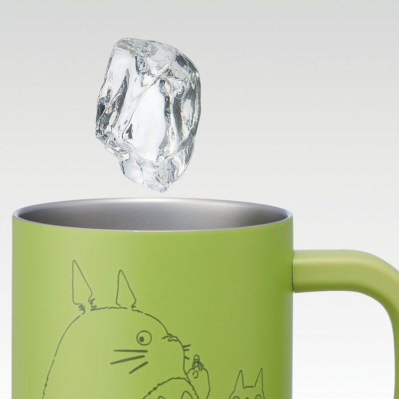 Light green Totoro mug with ice cube demonstrating double-wall insulation keeping drinks cold