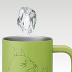 Light green Totoro mug with ice cube demonstrating double-wall insulation keeping drinks cold