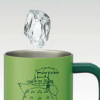 Close-up of Totoro travel mug interior with ice cube demonstrating cold drink use