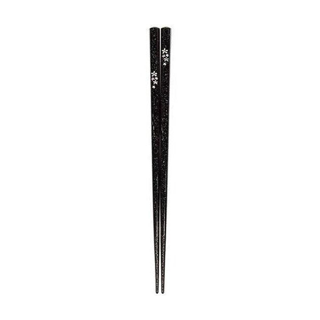 Close-up of black glitter chopsticks with silver cherry blossom design