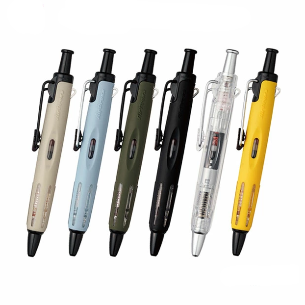 Assorted Tombow AirPress ballpoint pens in six colors with visible ink reservoirs