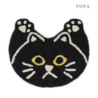 Black cat head shaped tufted cotton mat with cream paw ears and yellow eyes