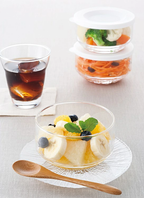 Glass food storage bowl filled with fruit salad in refrigerator setting