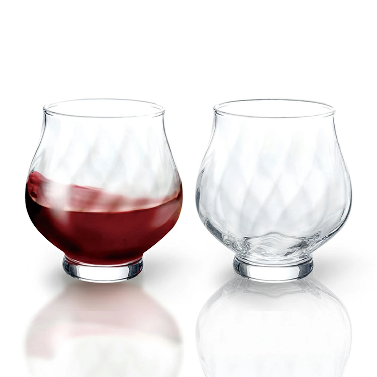 Stemless wine glasses with faceted pattern, one filled with red wine