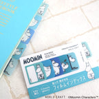 Blue Moomin film index tabs on notebook edge with packaging card