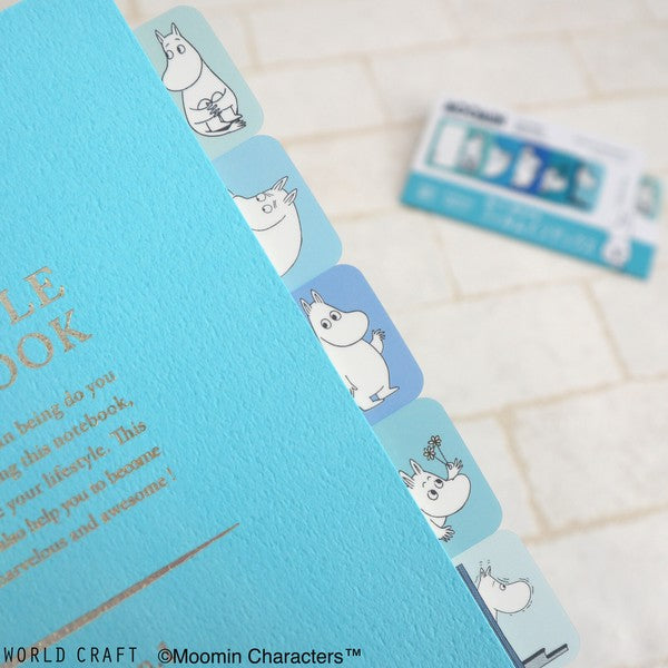 Vertical column of blue Moomin character index tabs on textured notebook