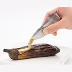 EAtoco precision tongs lifting eggplant flesh with engraved logo