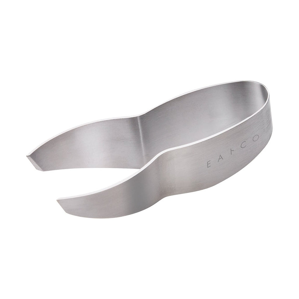 Stainless steel tongs extracting fish bone from salmon fillet