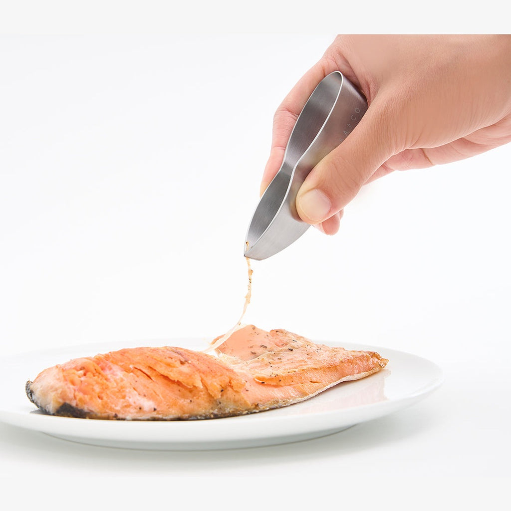 One-piece brushed stainless steel EAtoco tongs open on white background