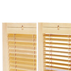 Close-up of adjustable blind-style slat mechanism on wood partition
