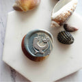 Marbled blue-gray wax seal with silver otter holding heart motif