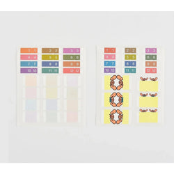 Hobonichi Index Stickers with numbered pastel tabs and crab designs