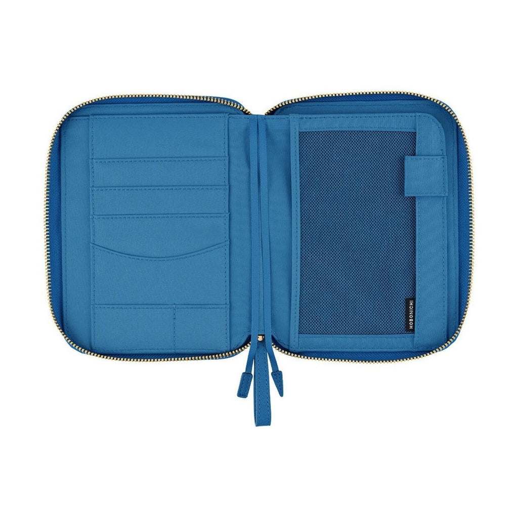 Interior view of blue Hobonichi cover featuring fabric pockets and mesh storage compartments