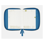 Open blue zippered Hobonichi planner displaying Friday and Saturday grid layouts with green tab