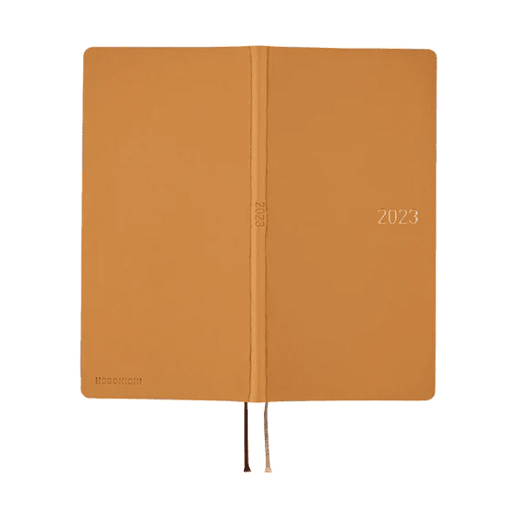 Open tan Hobonichi Techo 2023 showing front and back covers with dual ribbons