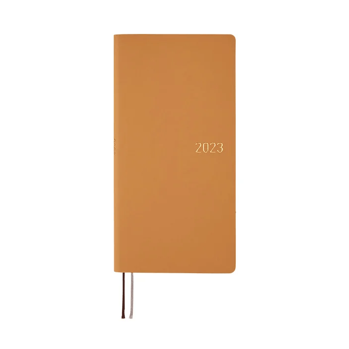 Warm orange Hobonichi Techo 2023 compact diary with gold embossed year
