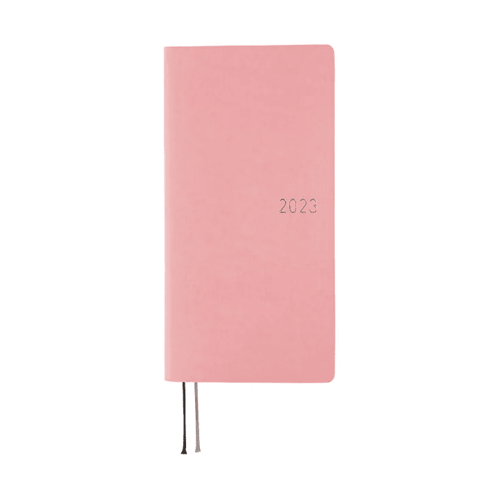 Pink Hobonichi Techo 2023 weekly planner with silver embossed year and ribbons
