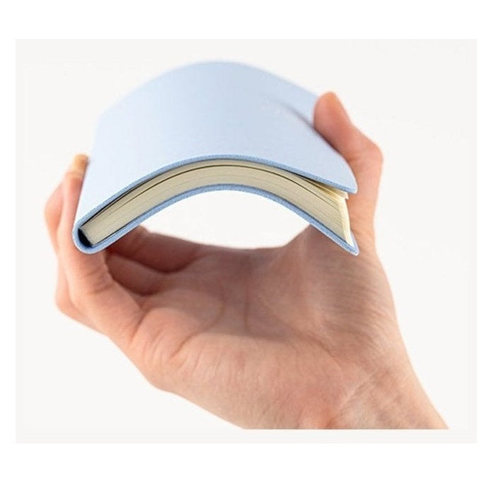 Light blue Hobonichi Techo 2023 flexible diary bent to show slim spine
