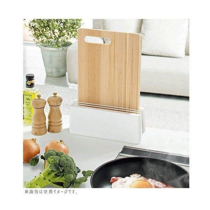 Wooden cutting board on white diatomaceous earth stand in modern kitchen setting