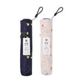 Two closed Nifty Colors mini umbrellas in navy and pink with labels
