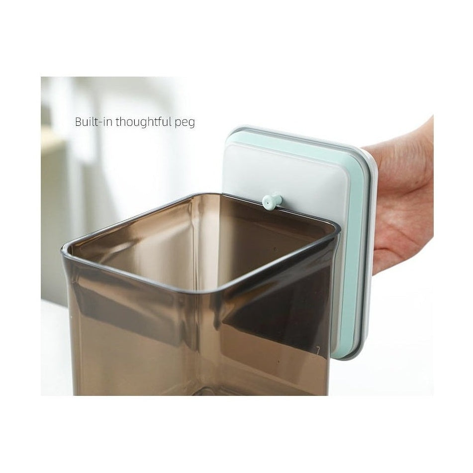 Brown airtight container lid showing built-in green peg for easy opening