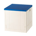 White foldable storage box with blue brick-stud lid and side handle cutout