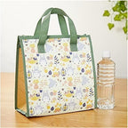 Totoro patterned insulated lunch tote bag with water bottle on wood surface