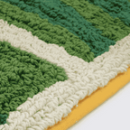 Corner detail of banana leaf mat showing green leaf sections and yellow border