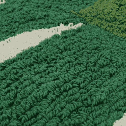 Macro shot of deep green plush cotton blend pile on banana leaf mat