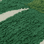 Macro shot of deep green plush cotton blend pile on banana leaf mat