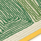 Close-up of Tomo banana leaf rug texture showing raised green yarn pattern